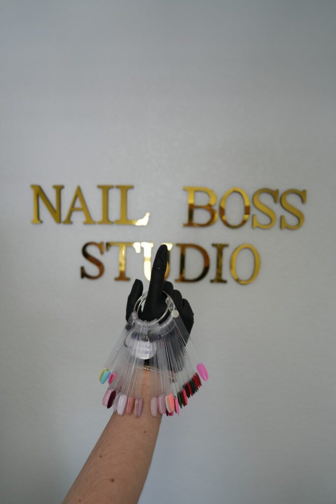 Professional nail artist showcasing builder gel manicure at Nail Boss Studio Tampa, Florida.