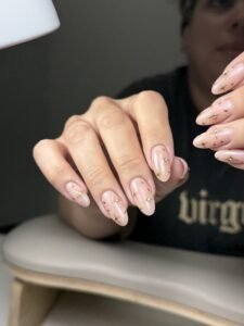 Soft pink nails with gold accents after a professional dry manicure in Tampa.