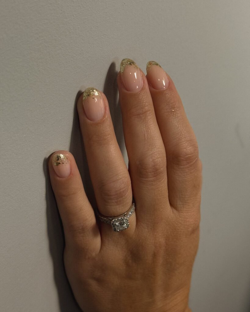 Soft nude nails with gold accents made using european manicure near me technique in Tampa.