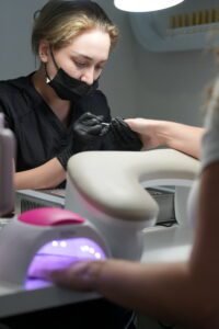 Nail artist performing european manicure near me in Tampa, Florida at Nail Boss Studio.