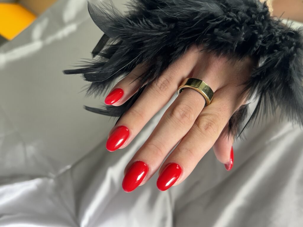 Glossy red nails created using russian manicure near me technique in Tampa.