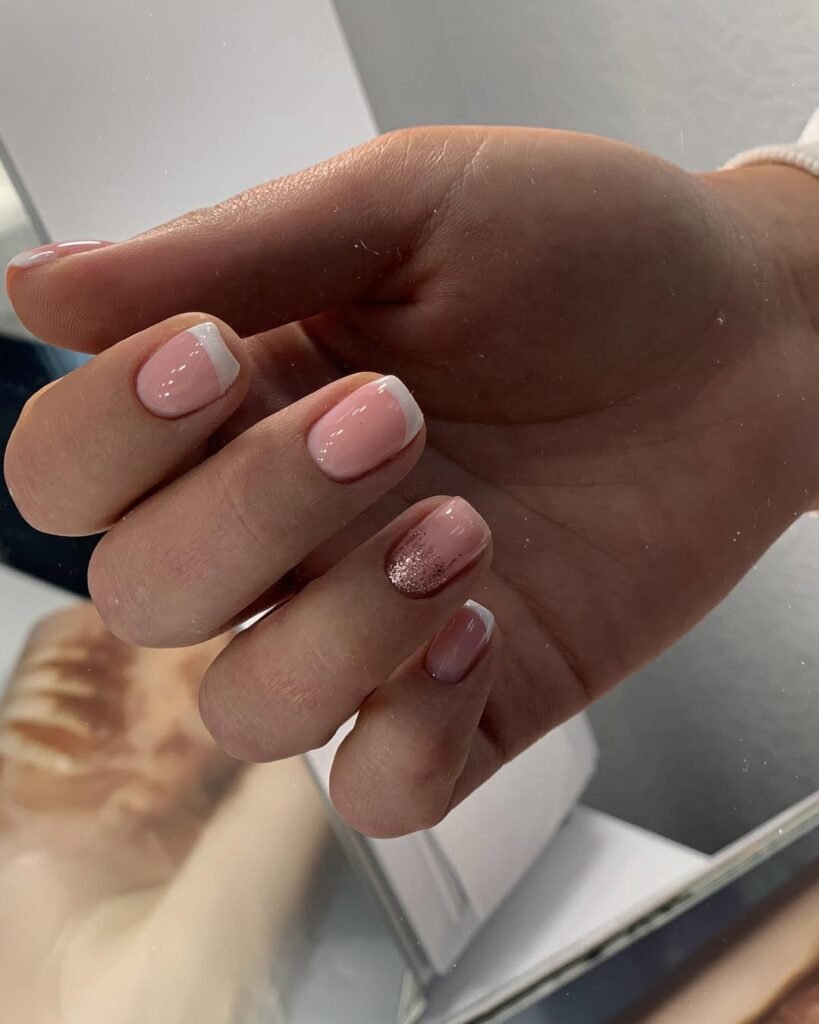 Soft pink French nails with glitter accent created using russian manicure Tampa technique.