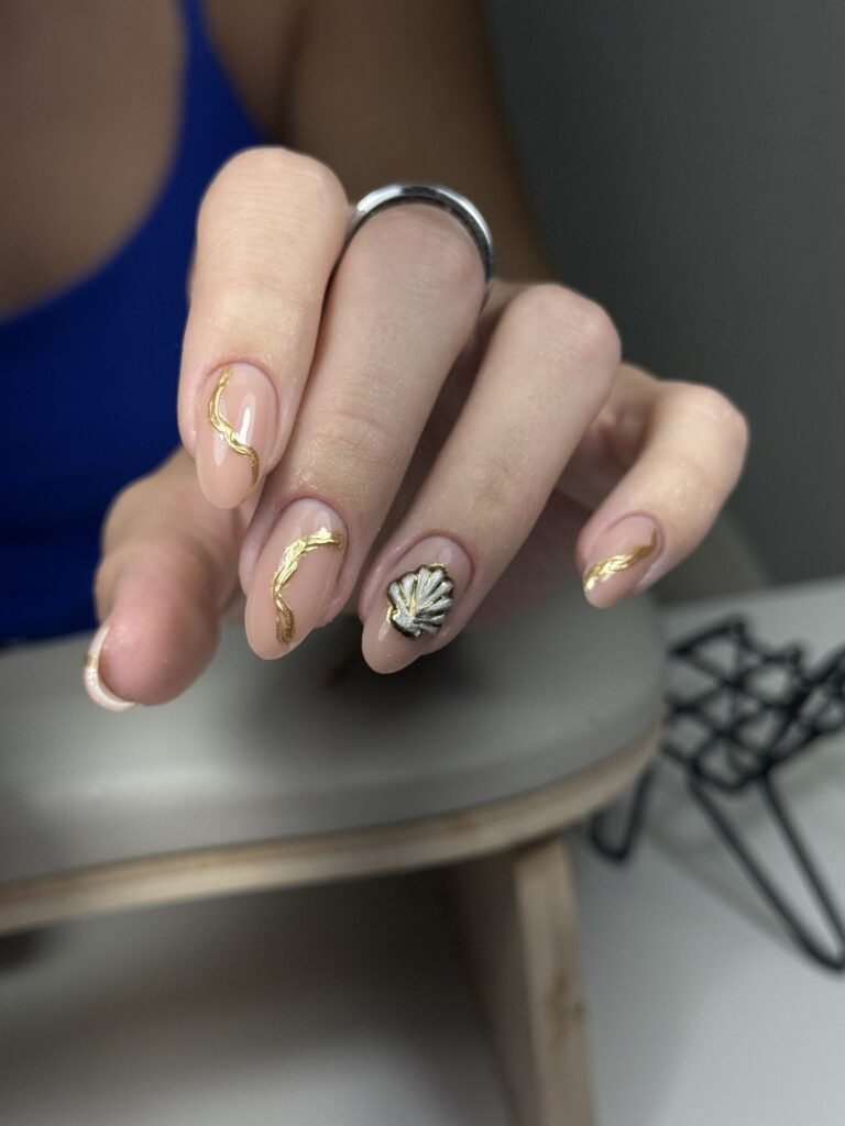Natural nude manicure with gold wave details created using russian manicures Tampa technique at Nail Boss Studio.