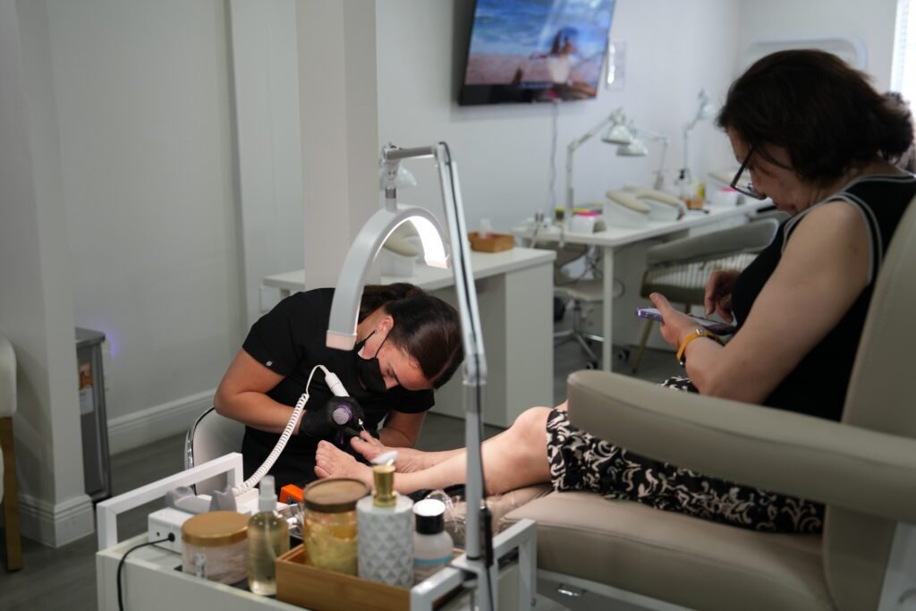 Nail artist performing russian nails tampa pedicure service in Tampa, Florida.