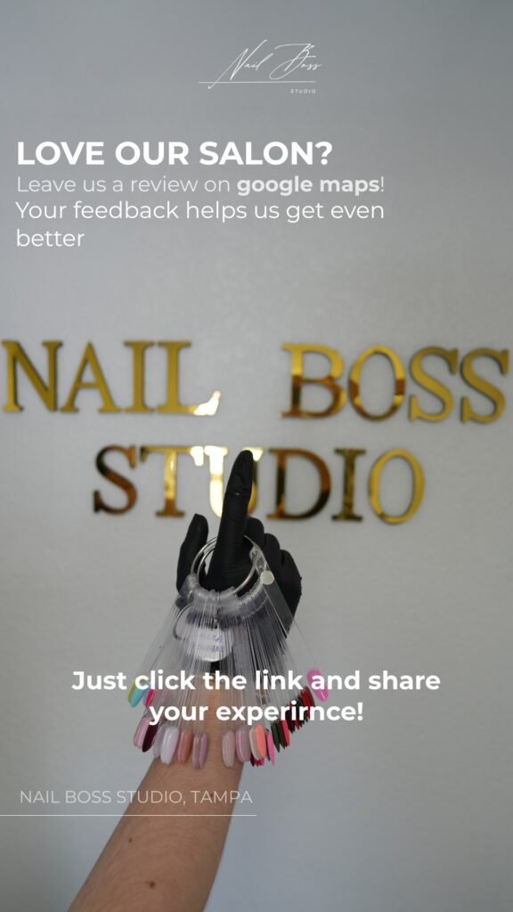 Professional nail artist holding polish samples at Nail Boss Studio Tampa, showcasing russian nails Tampa service.