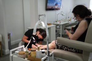 Nail artist performing russian nails tampa pedicure service in Tampa, Florida.