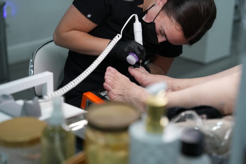 Nail artist performing smart pedicure tampa treatment in a professional salon.