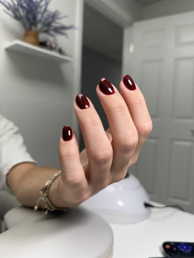 Deep red nails after russian manicure near me in Tampa, Florida.
