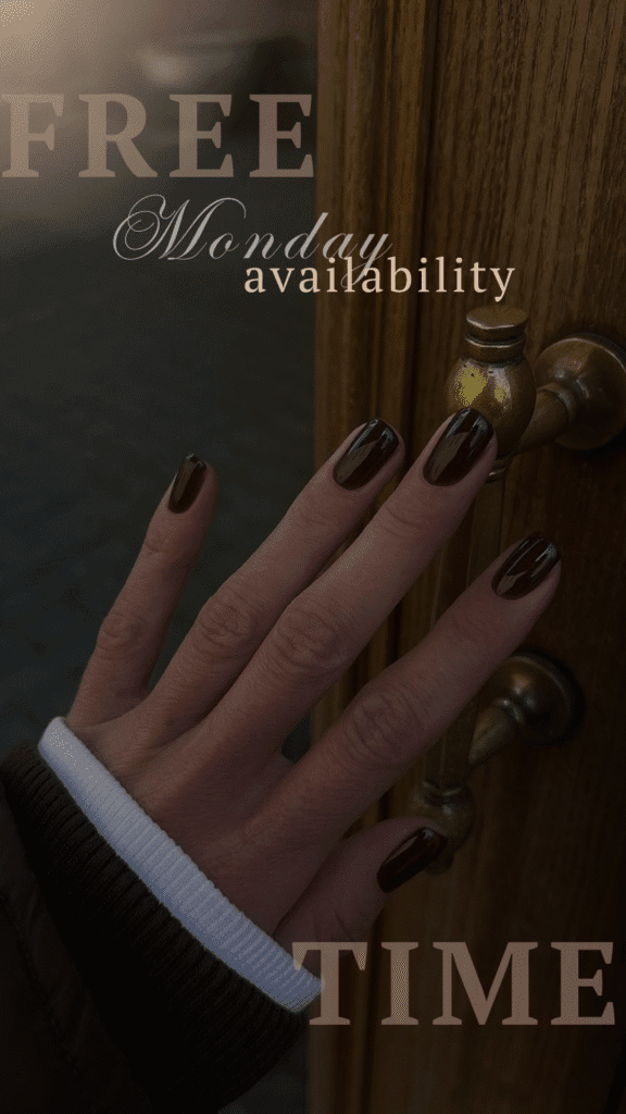 Hand with dark nails on a brass door handle, showing elegant dry manicure in Tampa.