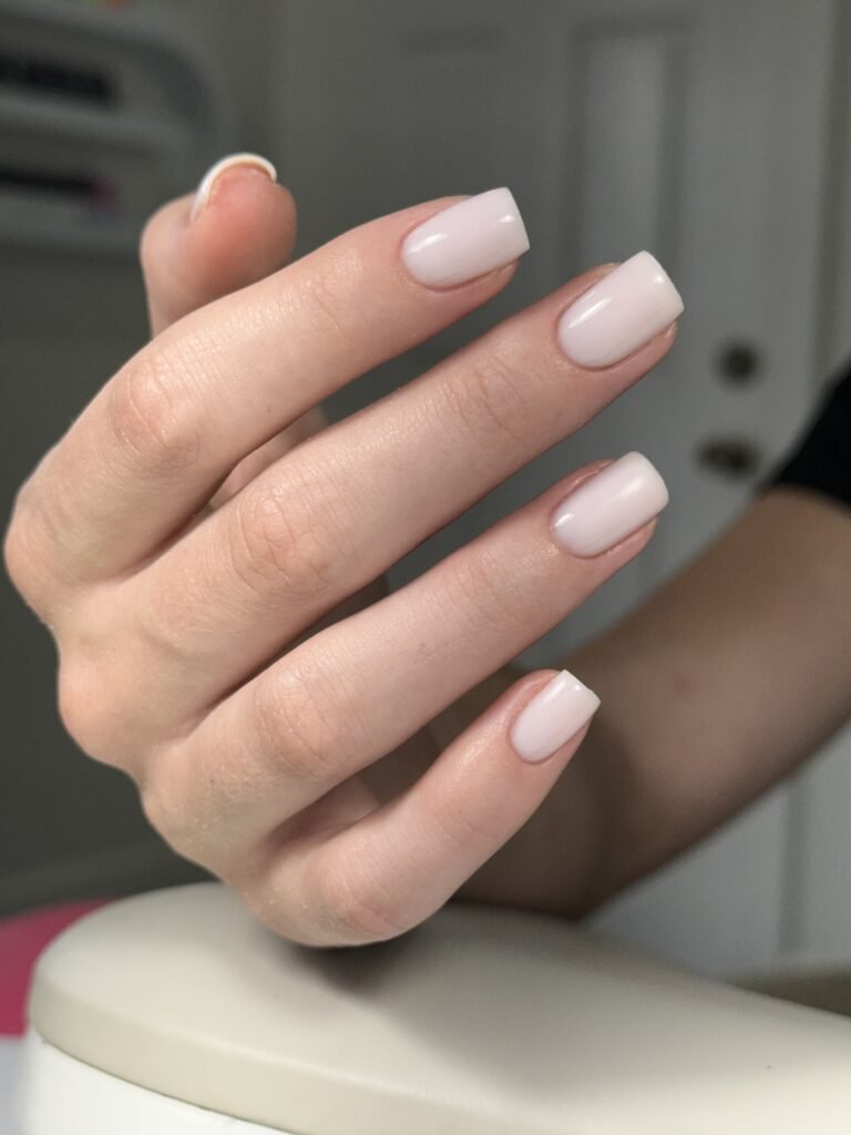 Close-up of soft nude nails after russian manicure near me in Tampa, Florida.