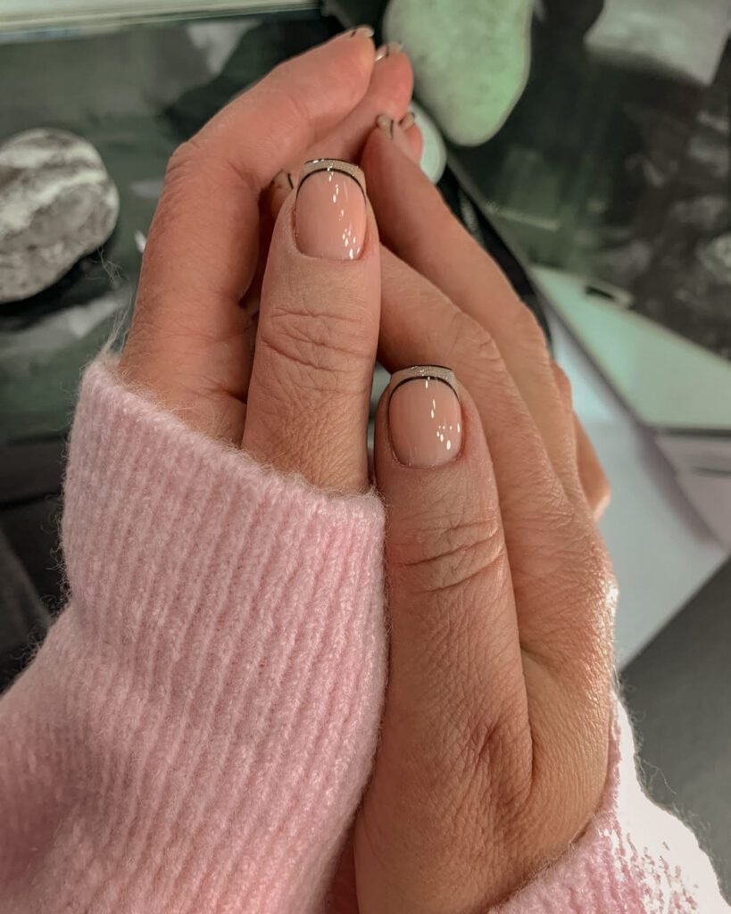 Hands with soft pink russian manicure near me in Tampa, Florida, glowing under natural light.