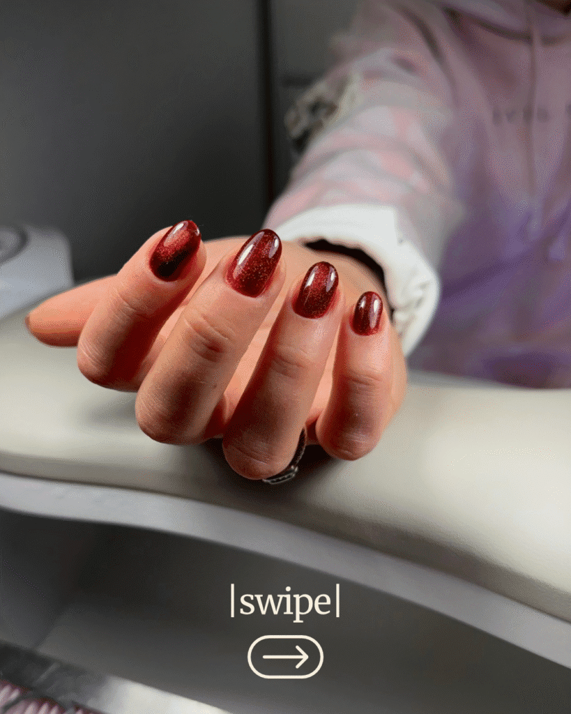 Elegant dark red nails after russian manicure near me in Tampa, Florida, under warm light.