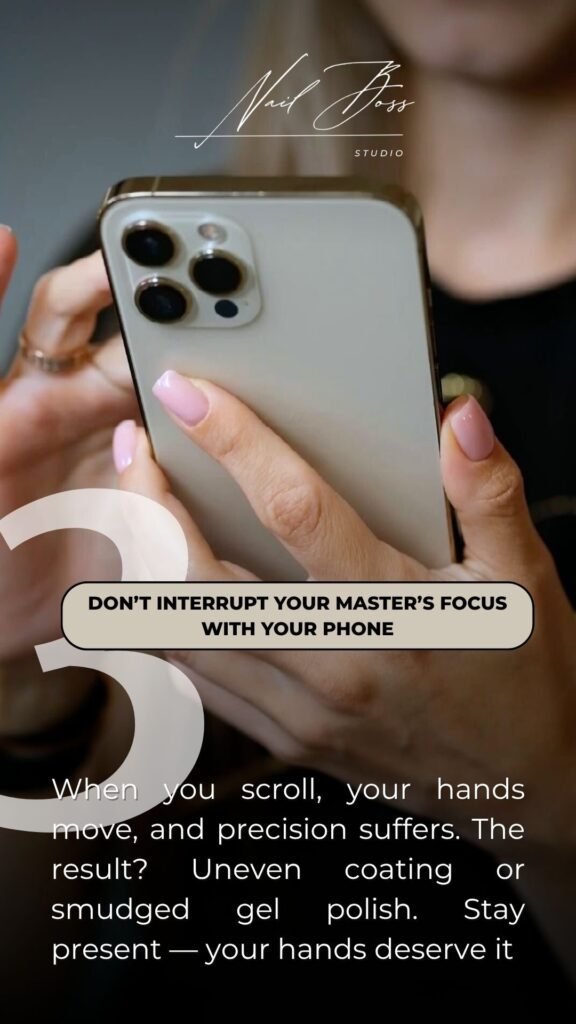 Client holding phone with freshly done russian manicure near me in Tampa, Florida.
