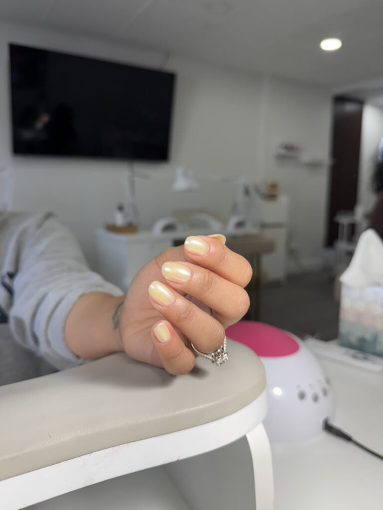 Hand with soft milky winter nails after a russian manicure near me in Tampa.