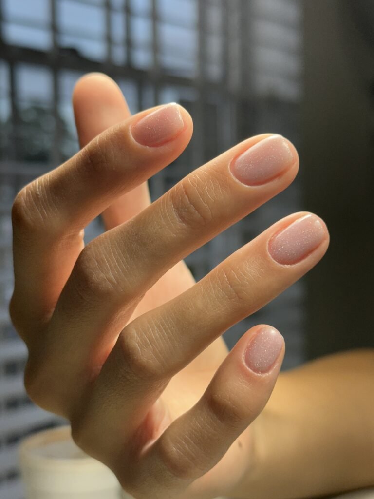 Hand with soft natural gel nails after a russian manicure near me in Tampa.