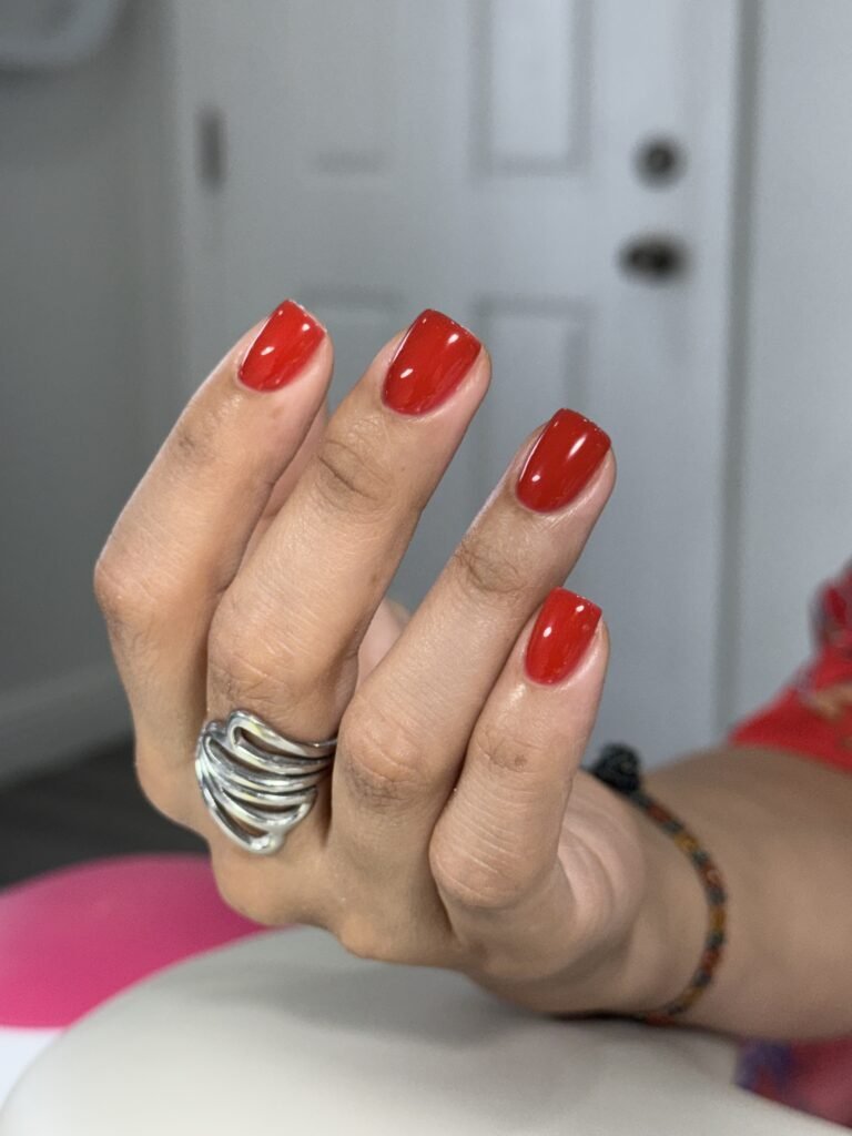 Vibrant red nails after russian manicure near me in Tampa, Florida.