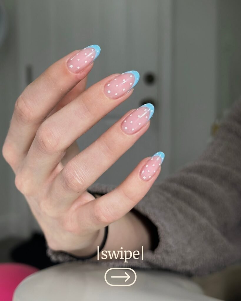 Hand with pastel blue French nails and dots, created using russian manicure Tampa technique.