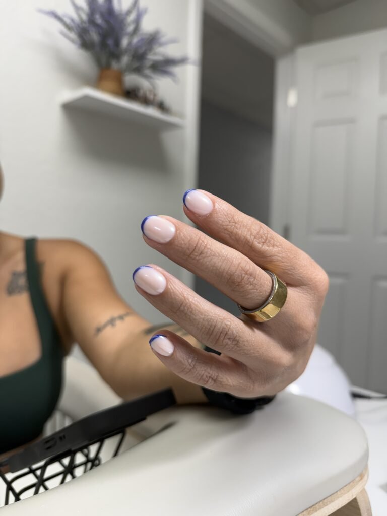 Elegant short nails with blue French tip after russian manicure in Tampa, Florida.