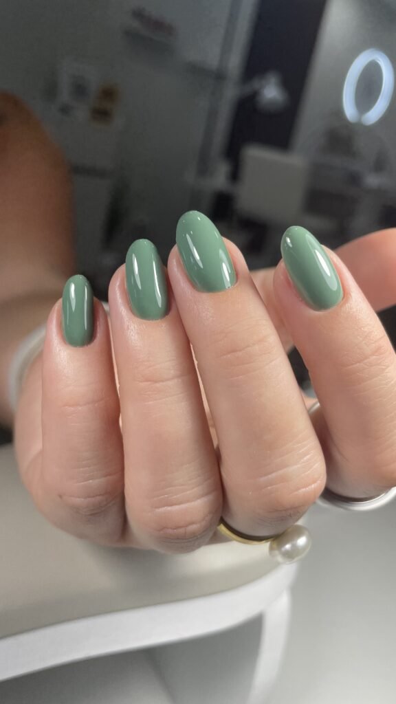 Green glossy oval manicure at a russian nail salon in Tampa.