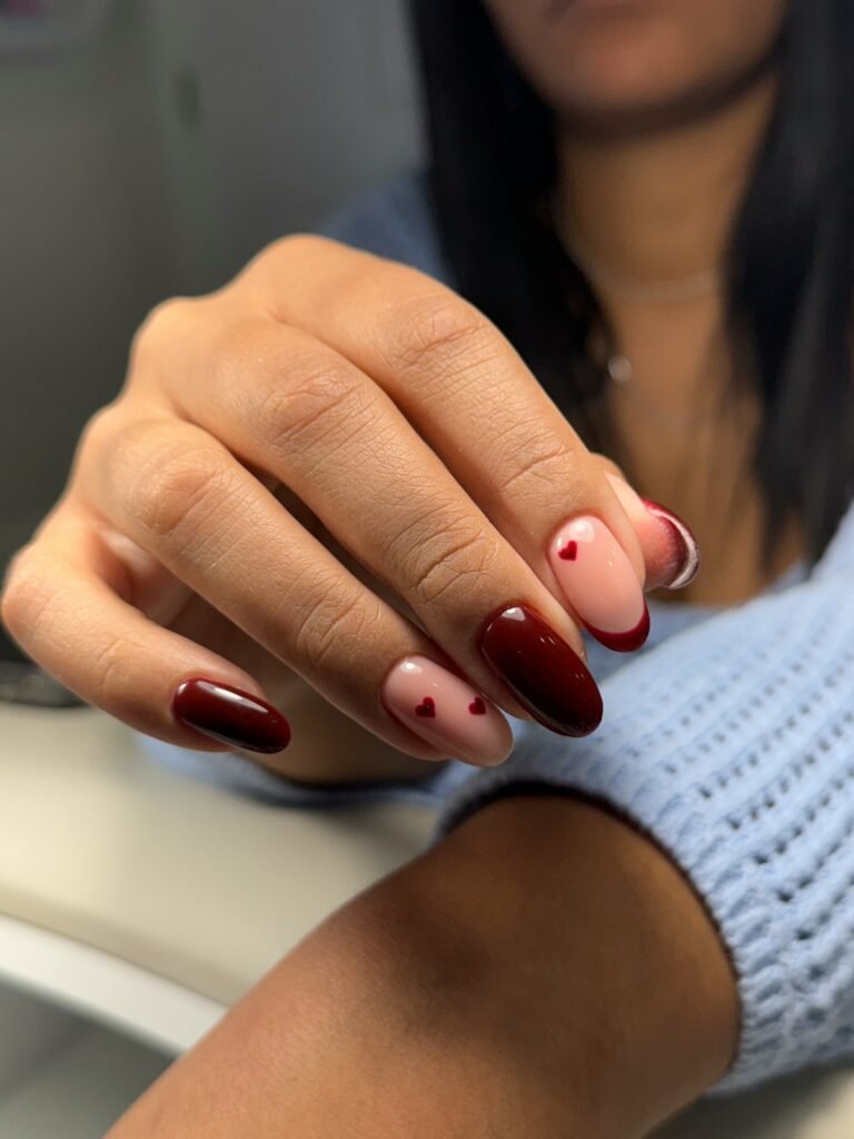 Close-up of a Tampa Russian manicure with red and nude heart design in Tampa, Florida.
