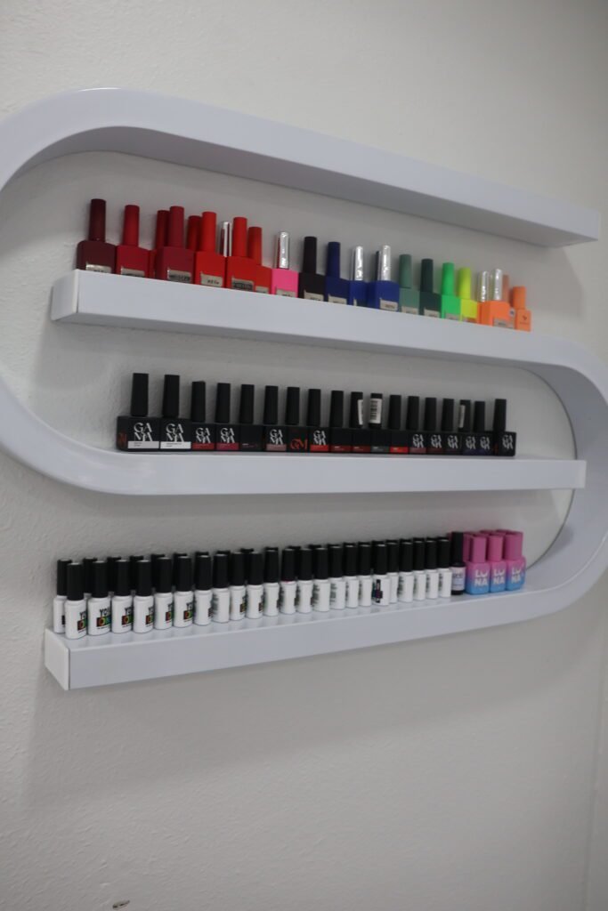builder gel manicure polish shelves inside a Tampa nail studio with bright colors