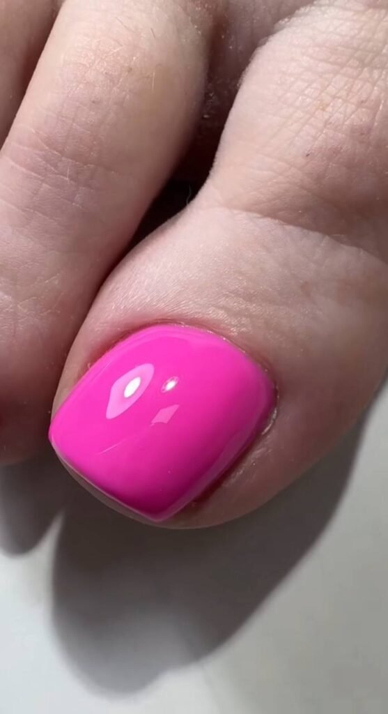 Dry pedicure Tampa with smooth skin and bright pink nail finish.