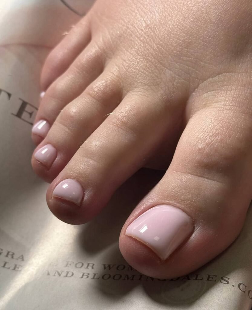 Gel pedicure Tampa with soft pink polish and clean cuticles in Florida