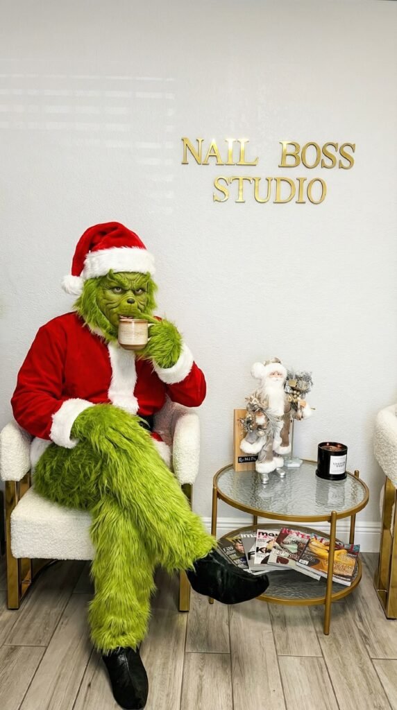 grinch sitting in Tampa nail salon promoting russian manicure near me