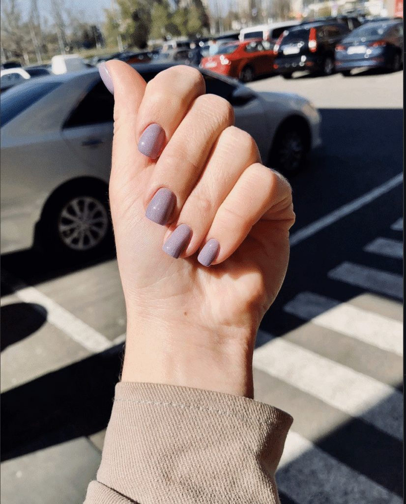 Russian manicure near me with soft nude finish photographed in natural daylight in Tampa.