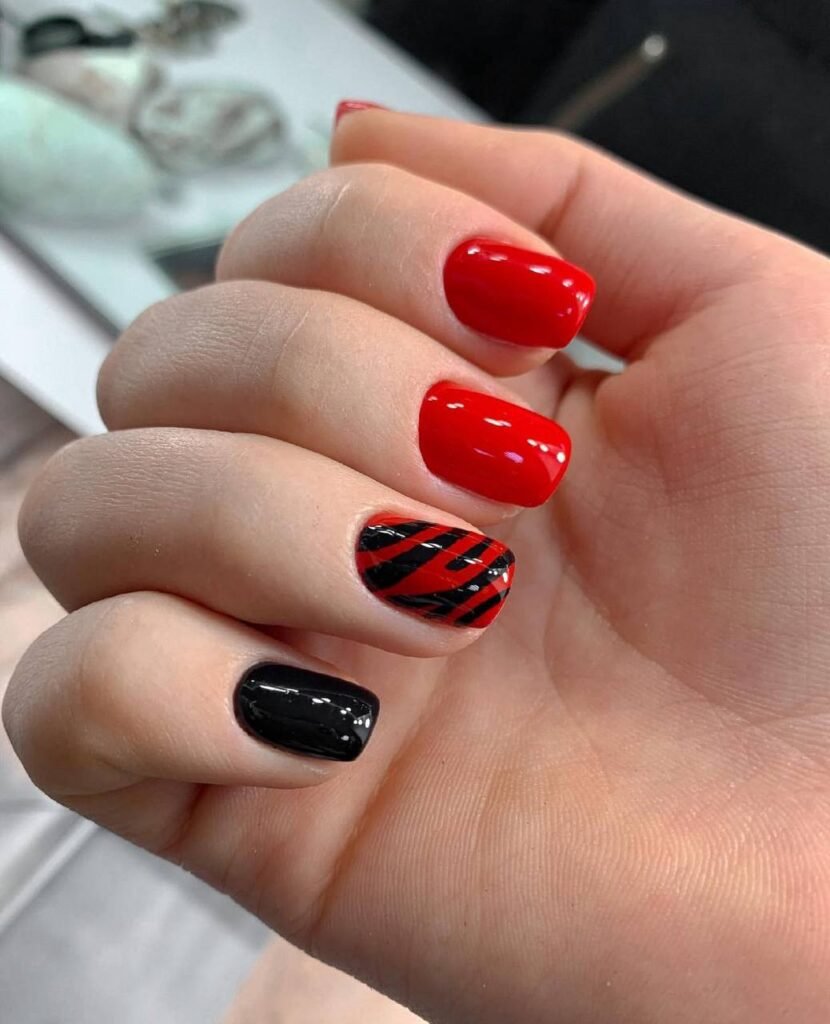 Bold red and black nails created with russian manicure technique in Tampa, Florida.