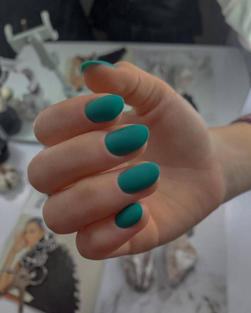 Matte teal nails created with russian manicures Tampa technique in Tampa, Florida.