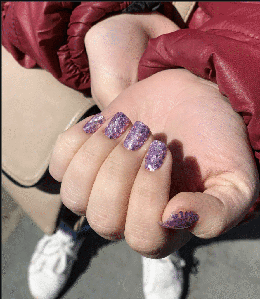 Russian manicures Tampa featuring glitter nails in natural sunlight at Nail Boss Studio.