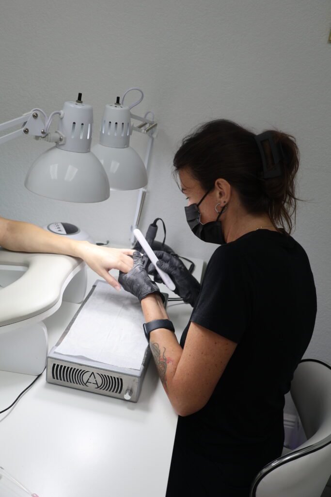 Nail technician performing russian nails in Tampa using safe builder gel technique.