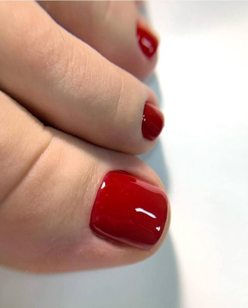 Close-up of glossy red toes after a russian pedicure near me in Tampa, Florida