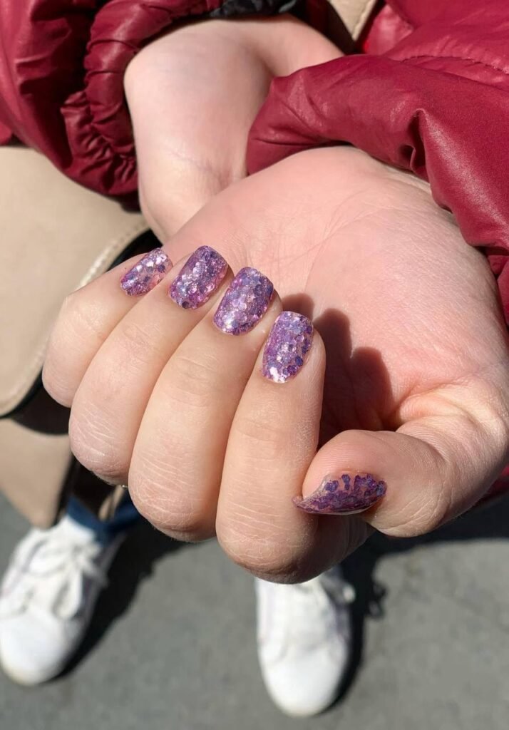 Glitter purple nails created with Tampa Russian Manicure in Tampa, Florida