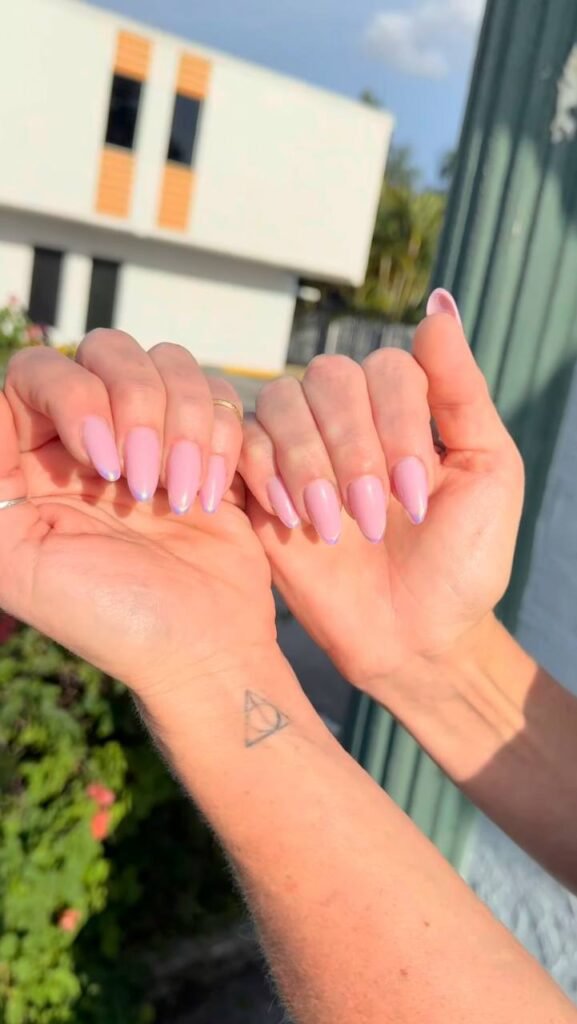 Soft pink builder gel manicure on almond nails in Tampa, Florida with clean structure and shine
