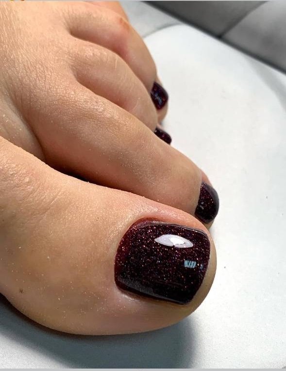 Close-up of a professional dry pedicure Tampa with deep gel color in a clean Florida studio