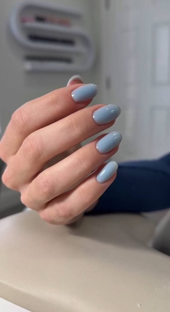 Elegant european manicure near me in Tampa with soft blue gel polish and clean cuticles.