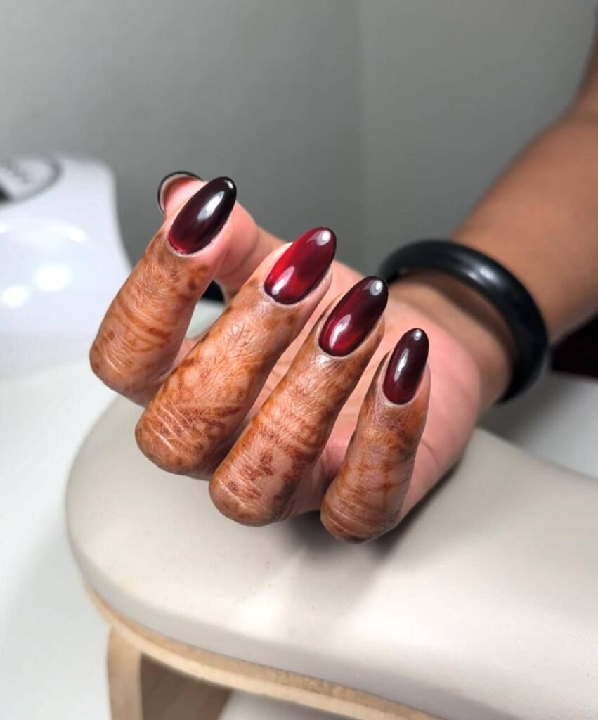 European manicure with deep red glossy nails on hands in Tampa, Florida nail studio