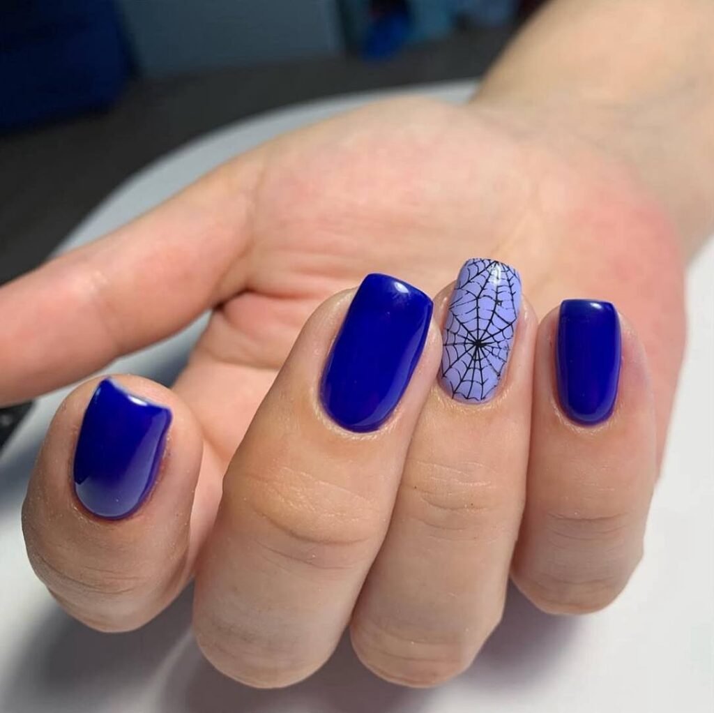 European manicure with deep blue polish and accent nail design in Tampa, Florida
