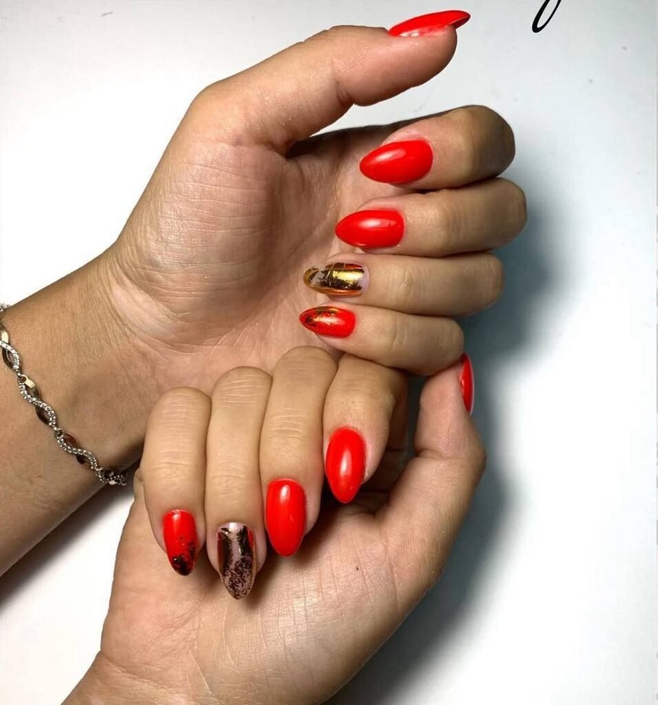 Elegant red russian manicure near me with gold accent details in Tampa, Florida
