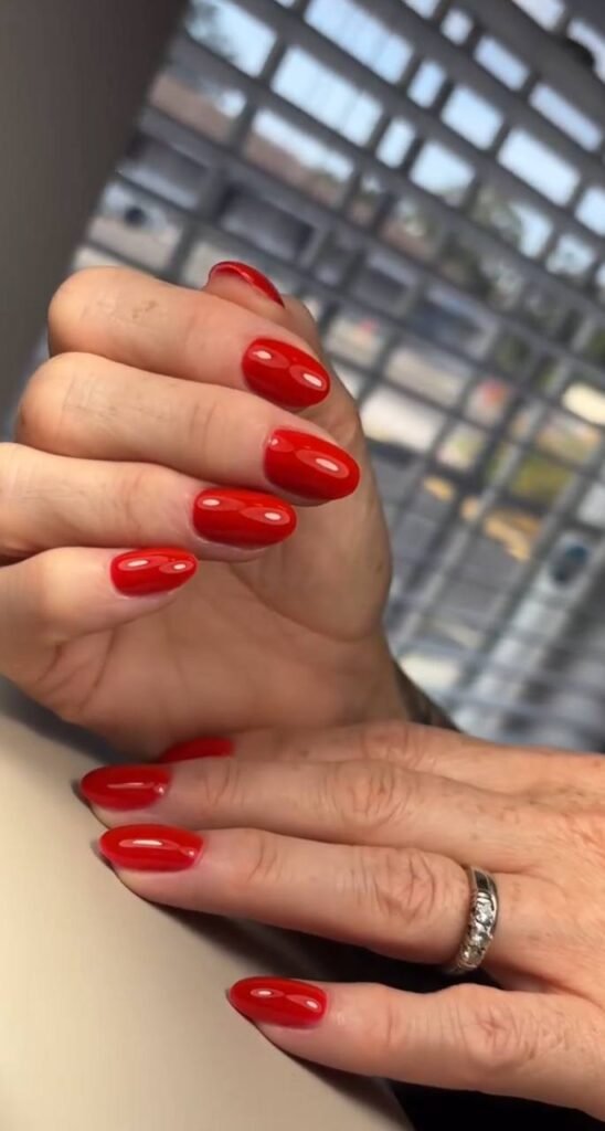 Elegant red russian manicure with glossy finish photographed in Tampa, Florida at Nail Boss Studio