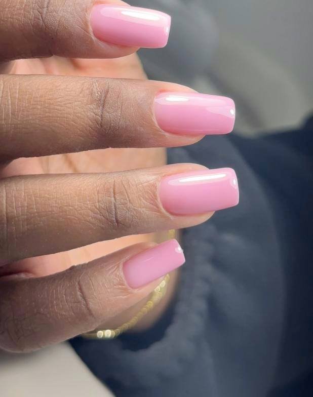 Glossy pink russian nails with clean cuticles in Tampa, Florida manicure studio.