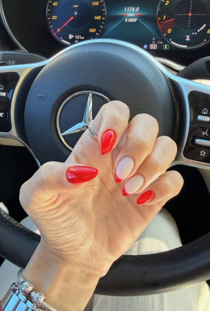 Red and nude russian nails tampa with almond shape inside a car in Tampa, Florida