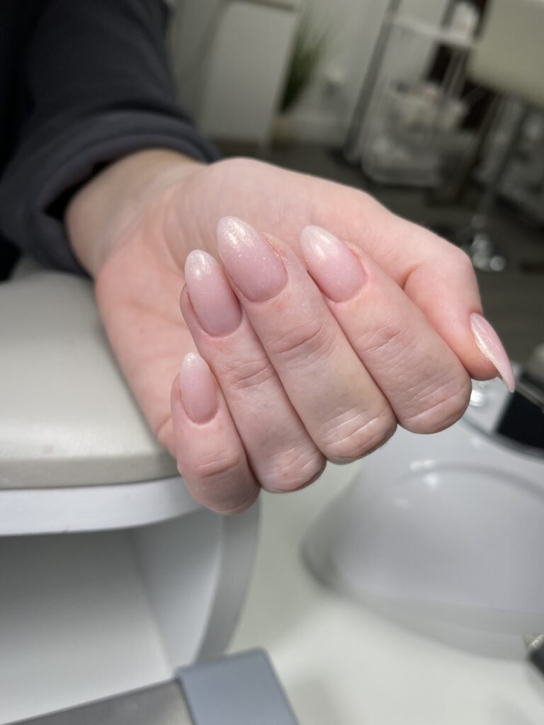 Natural almond-shaped builder gel manicure near me in Tampa with soft pink finish