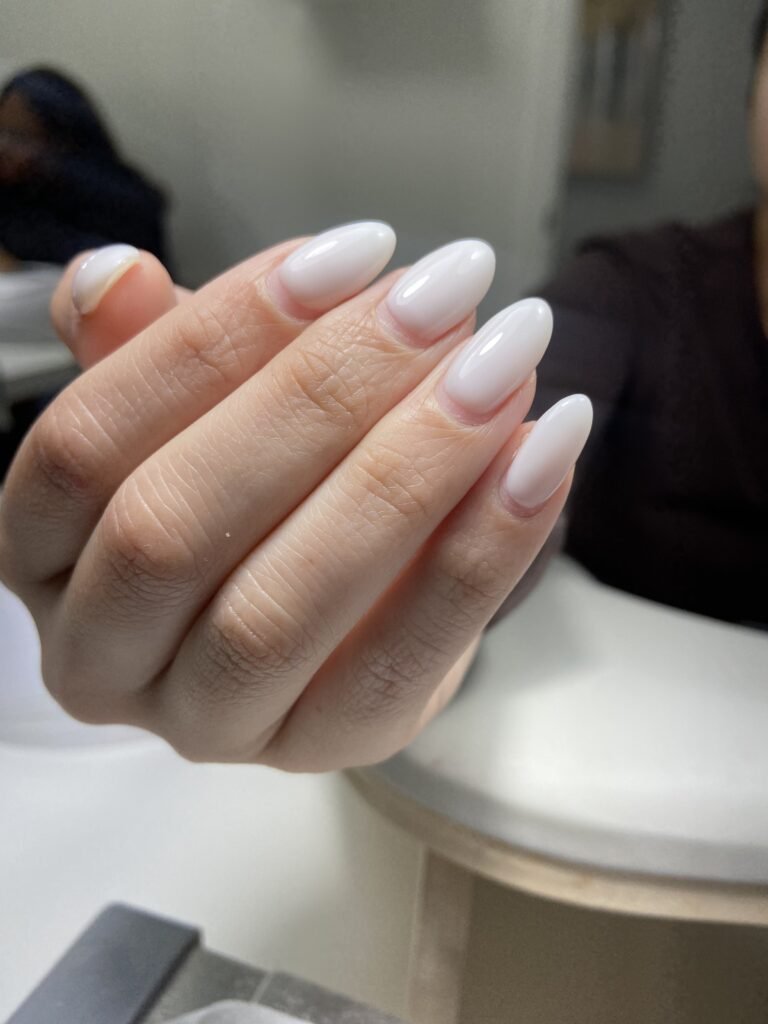 Natural glossy builder gel manicure on almond-shaped nails in Tampa, Florida