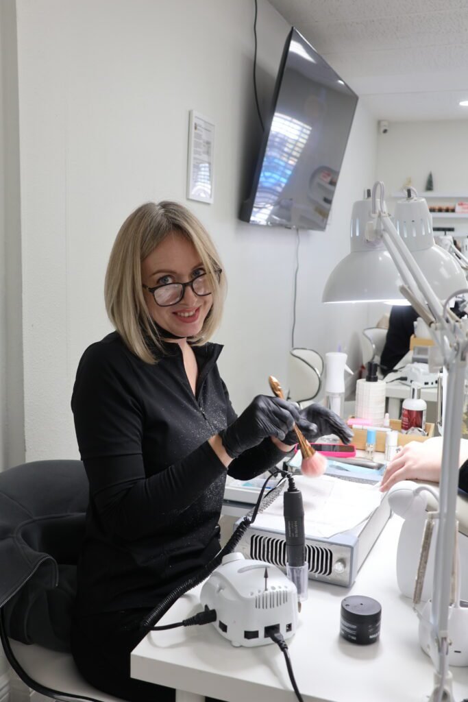 Nail technician creating structured natural manicure using builder gel Tampa in Tampa, Florida salon setting.