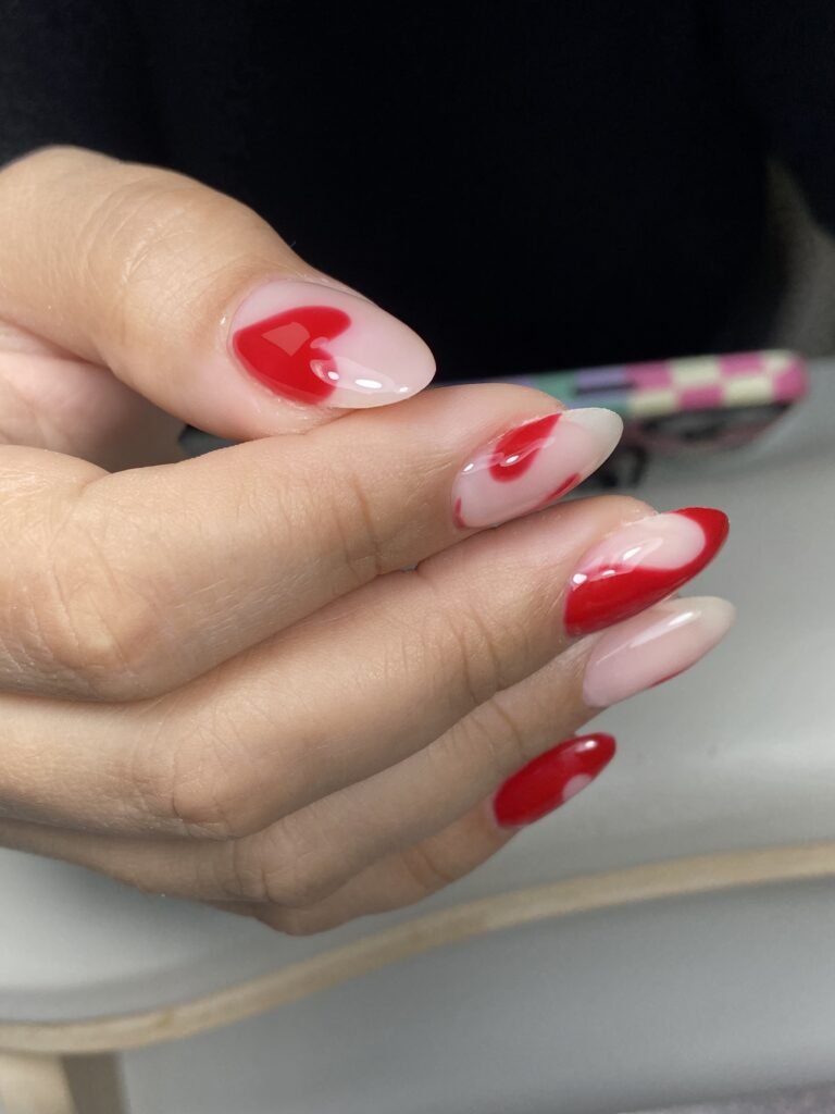 Close-up of elegant red hard gel russian manicure on natural nails in Tampa, Florida