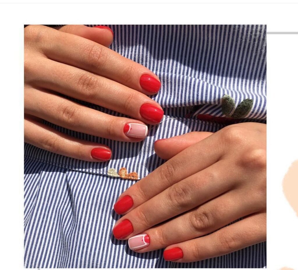 Red structured russian manicure in Tampa with minimalist accent design under natural Florida light.