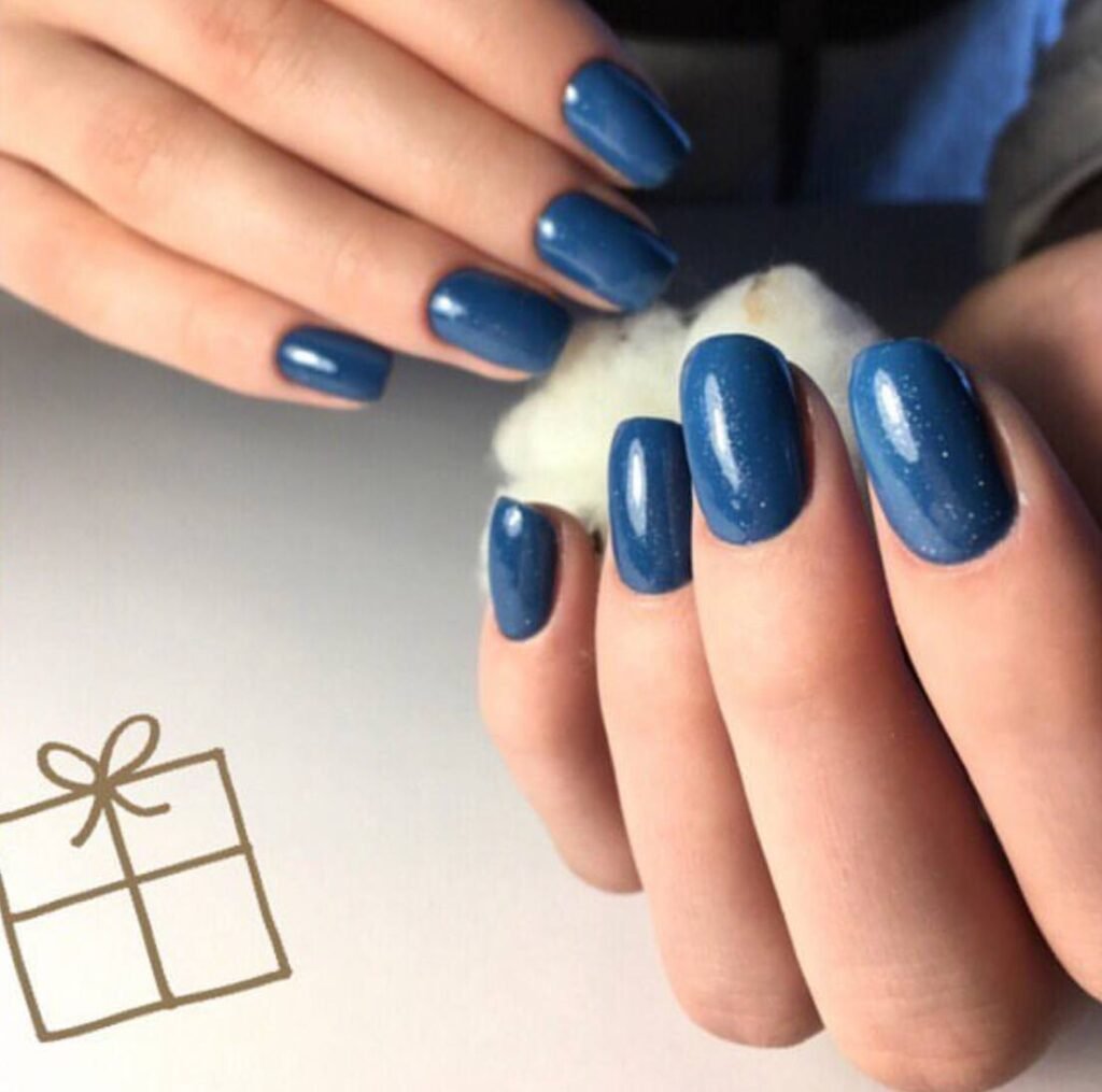 Blue glossy manicure created at a russian nail salon in Tampa, Florida with precise cuticle work and long lasting shine.